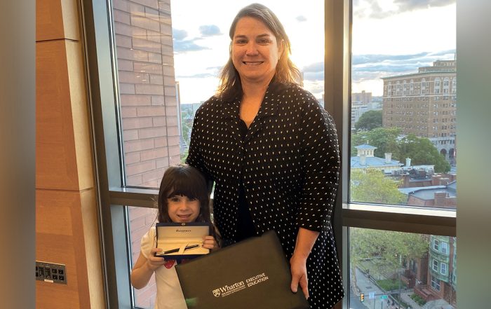 Christina S. holding certificate with daughter