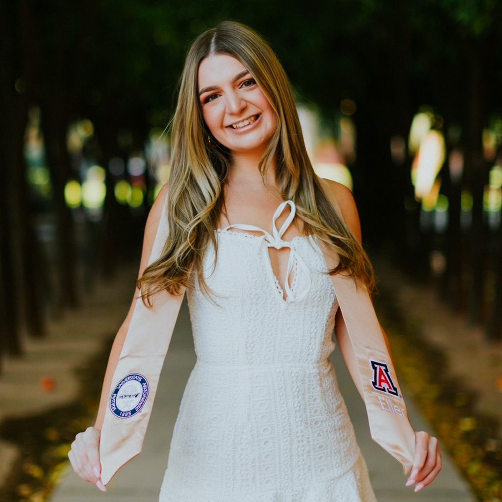 Graduation picture of Maycee holding her University of Arizona stole.